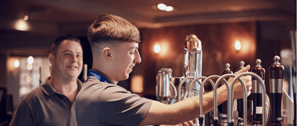 young bartender serving a customer
